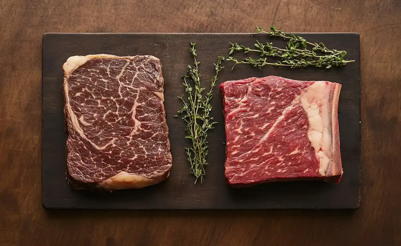 Close-up of a cooked picanha steak, showing its fat cap and texture.